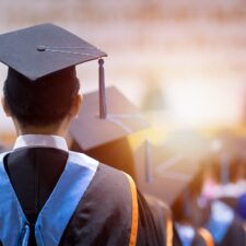 Rear,View,Of,University,Graduates,Wearing,Graduation,Gown,And,Cap